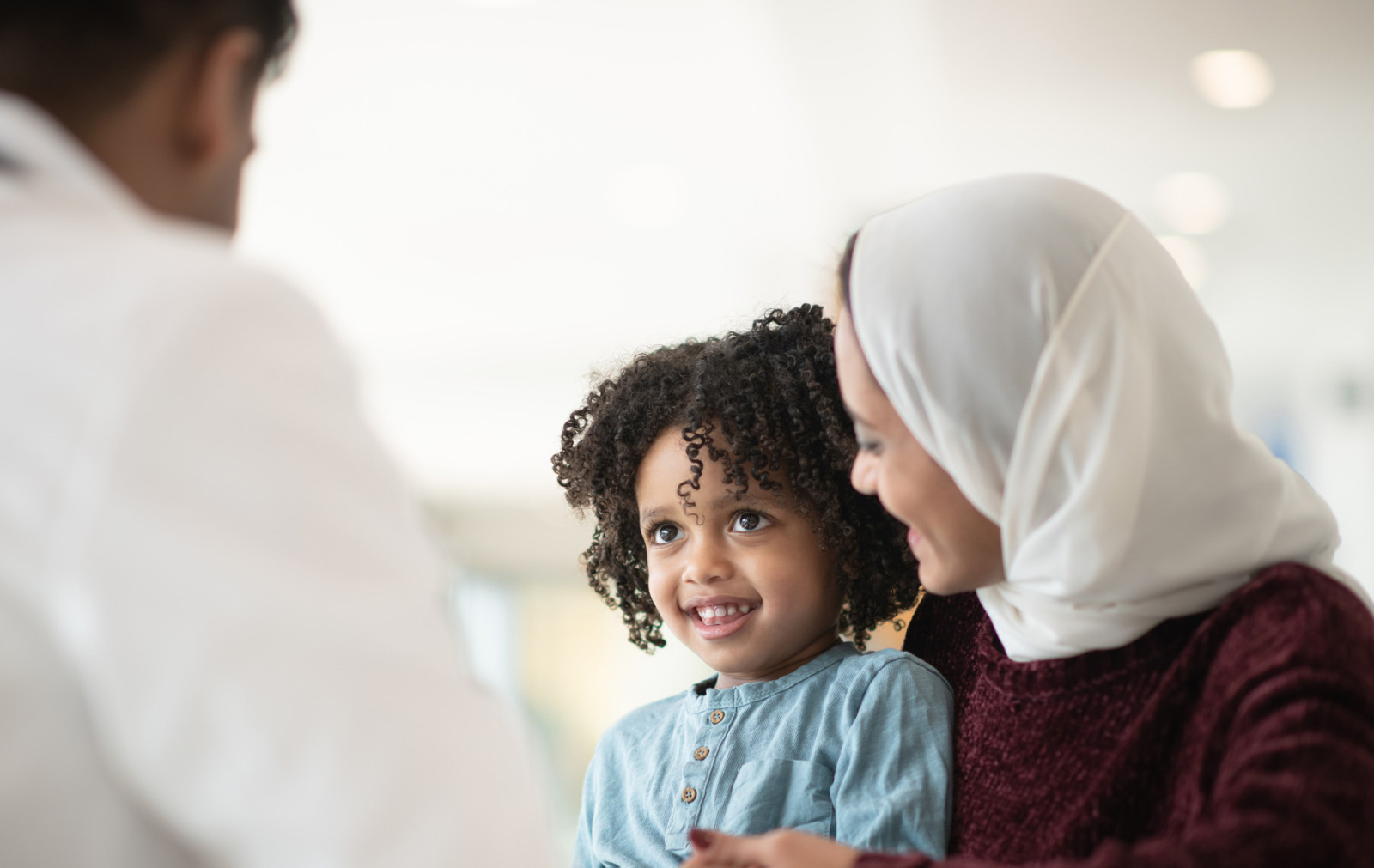 Mother and child speaking to pediatrician