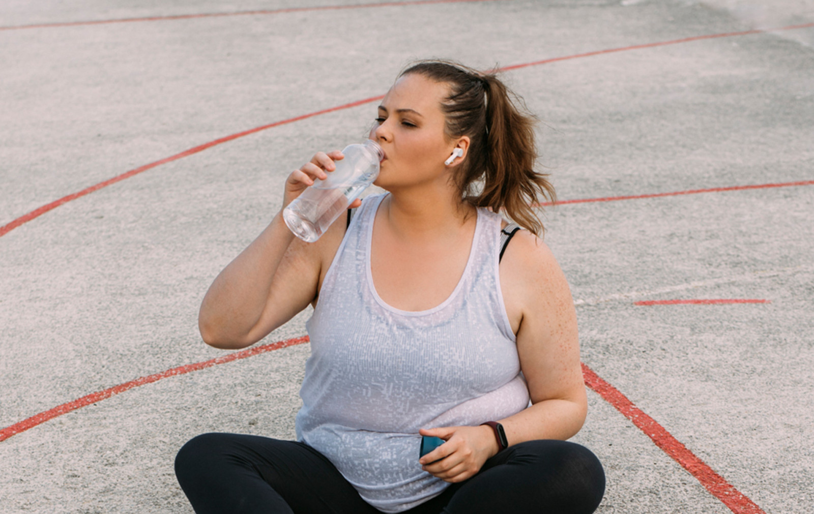 Woman post exercise drinking water