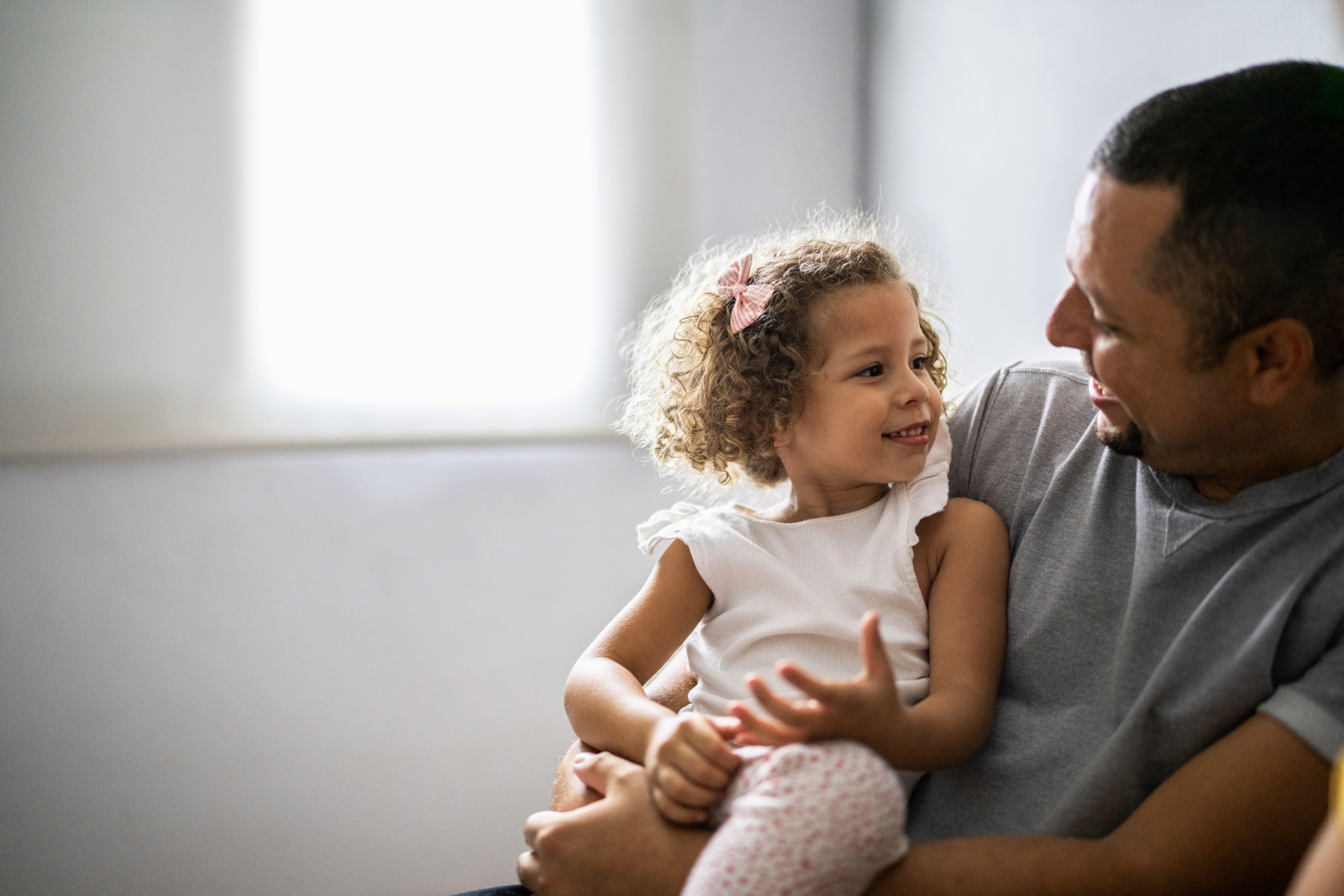 Daughter Sitting on Father's Lap