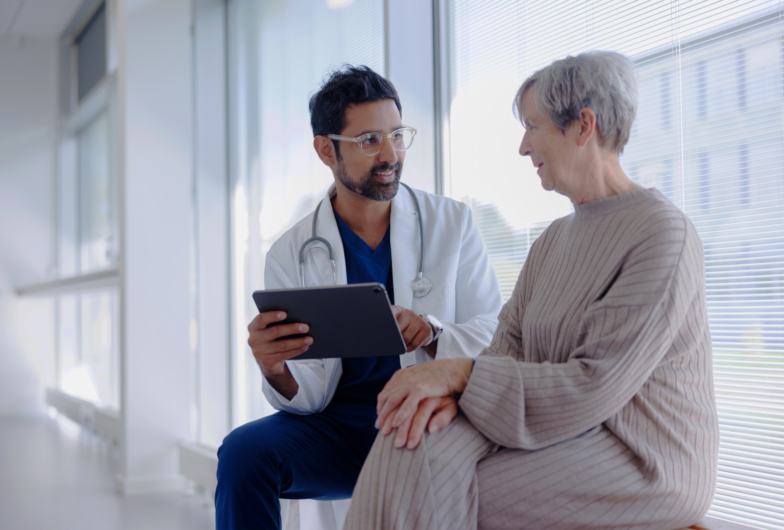 Doctor and Patient in Conversation Looking at Tablet