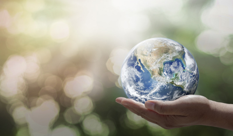 Hand holding Earth in palm