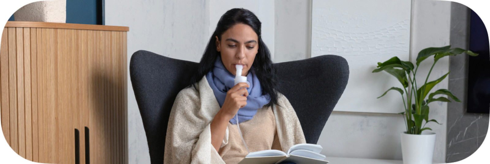Mother using nebulizer in chair