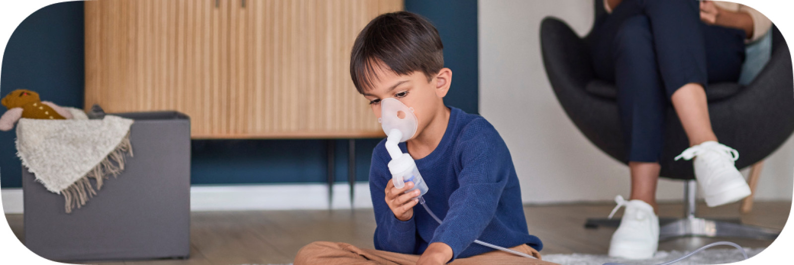 Child taking nebulizer treatment on floor