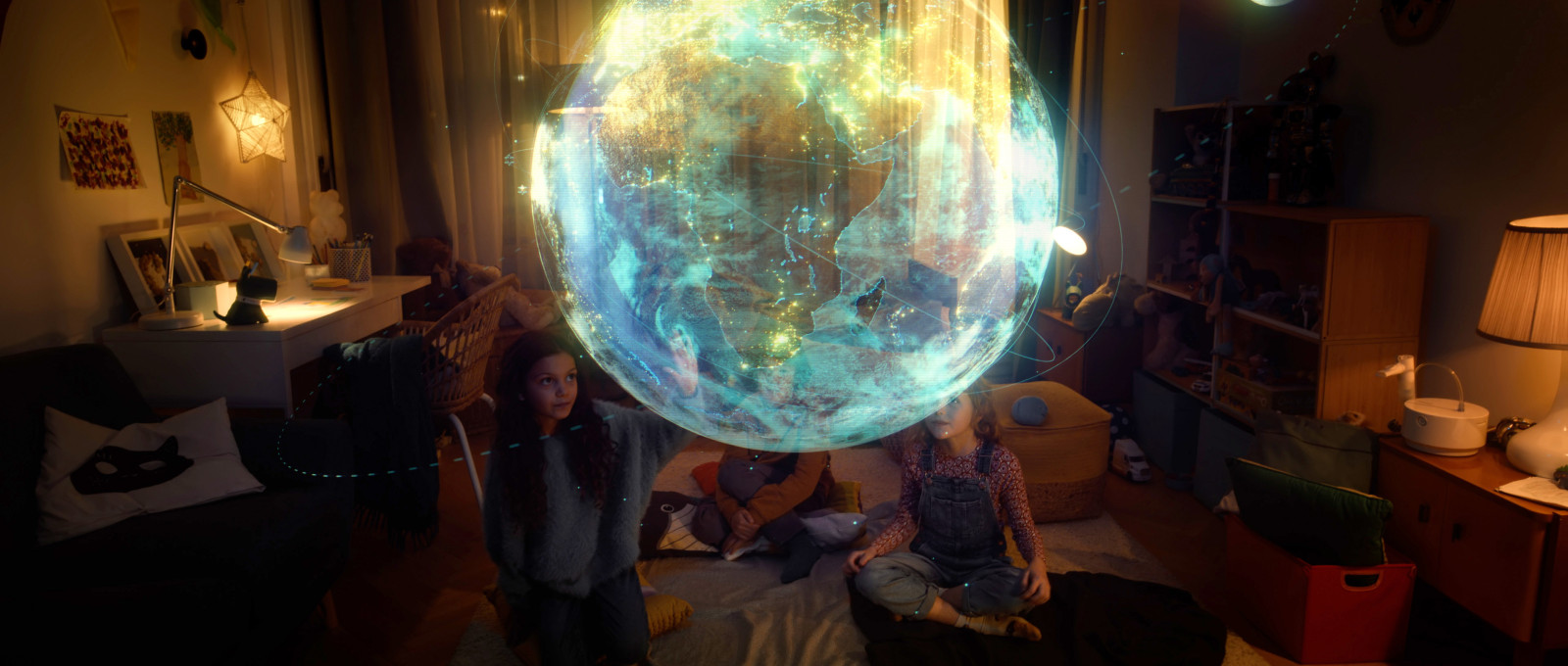 Two girls looking at hologram of earth in room
