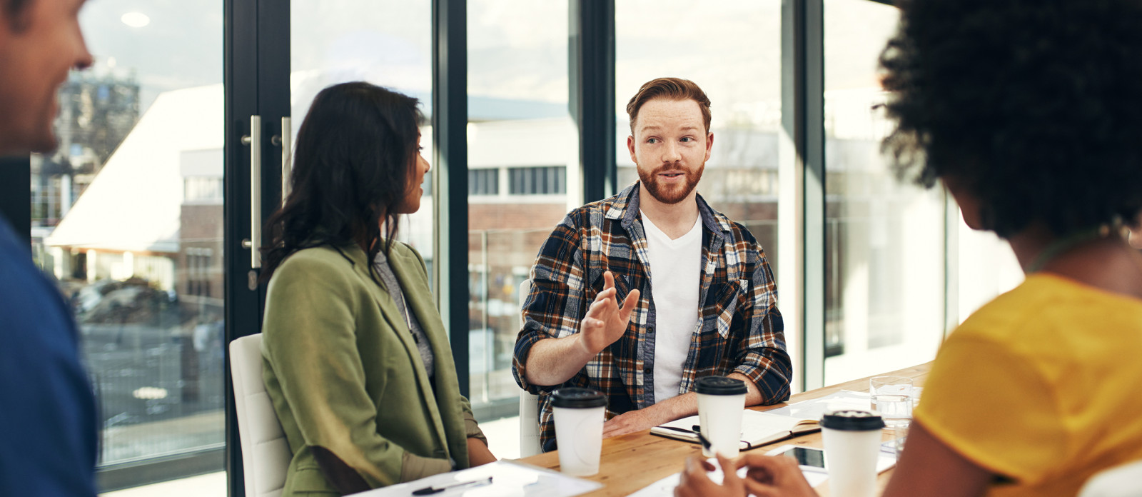People sitting at conference table speaking