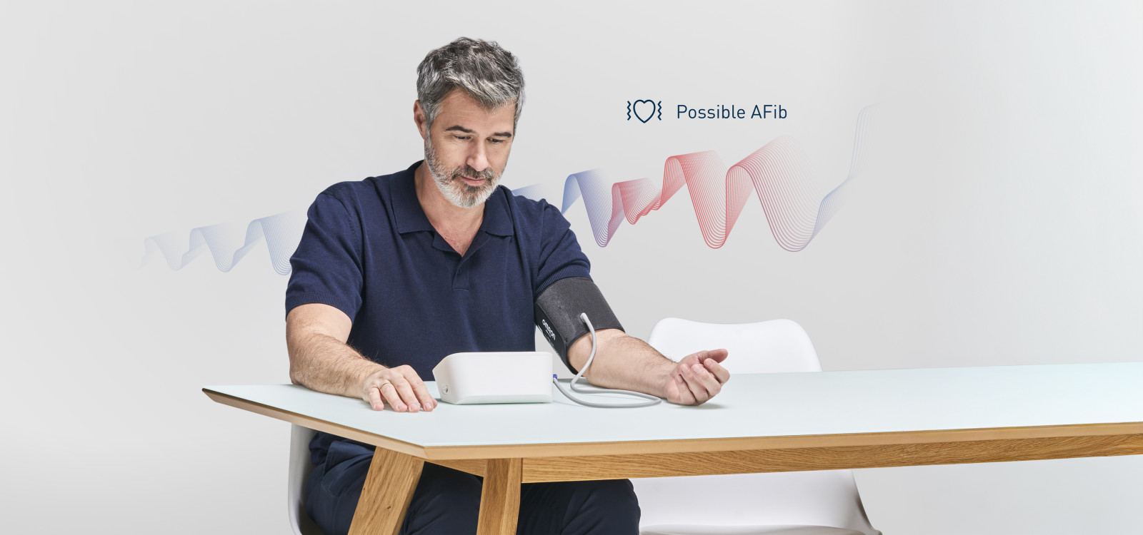 Man taking blood pressure monitor at home