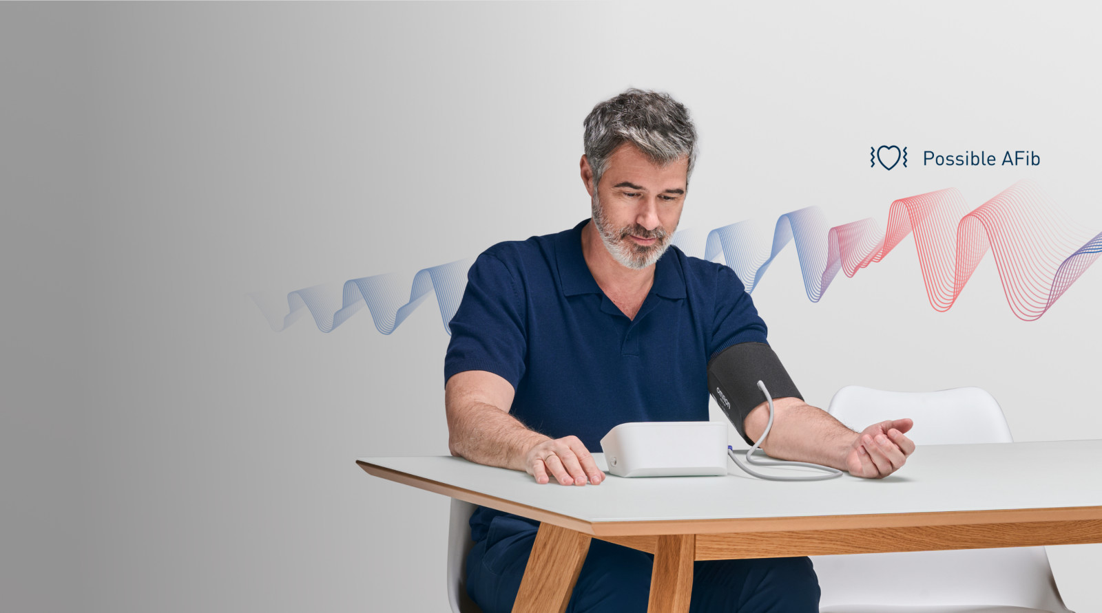 Man taking blood pressure monitor at home