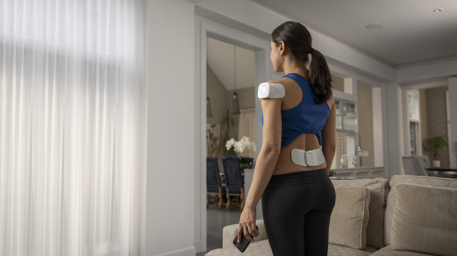 Woman standing using TENS units