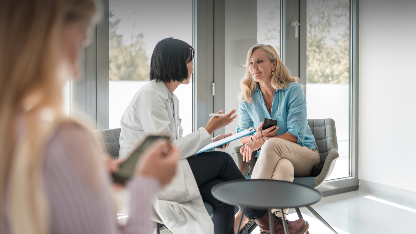 Doctor sitting in office talking to patient