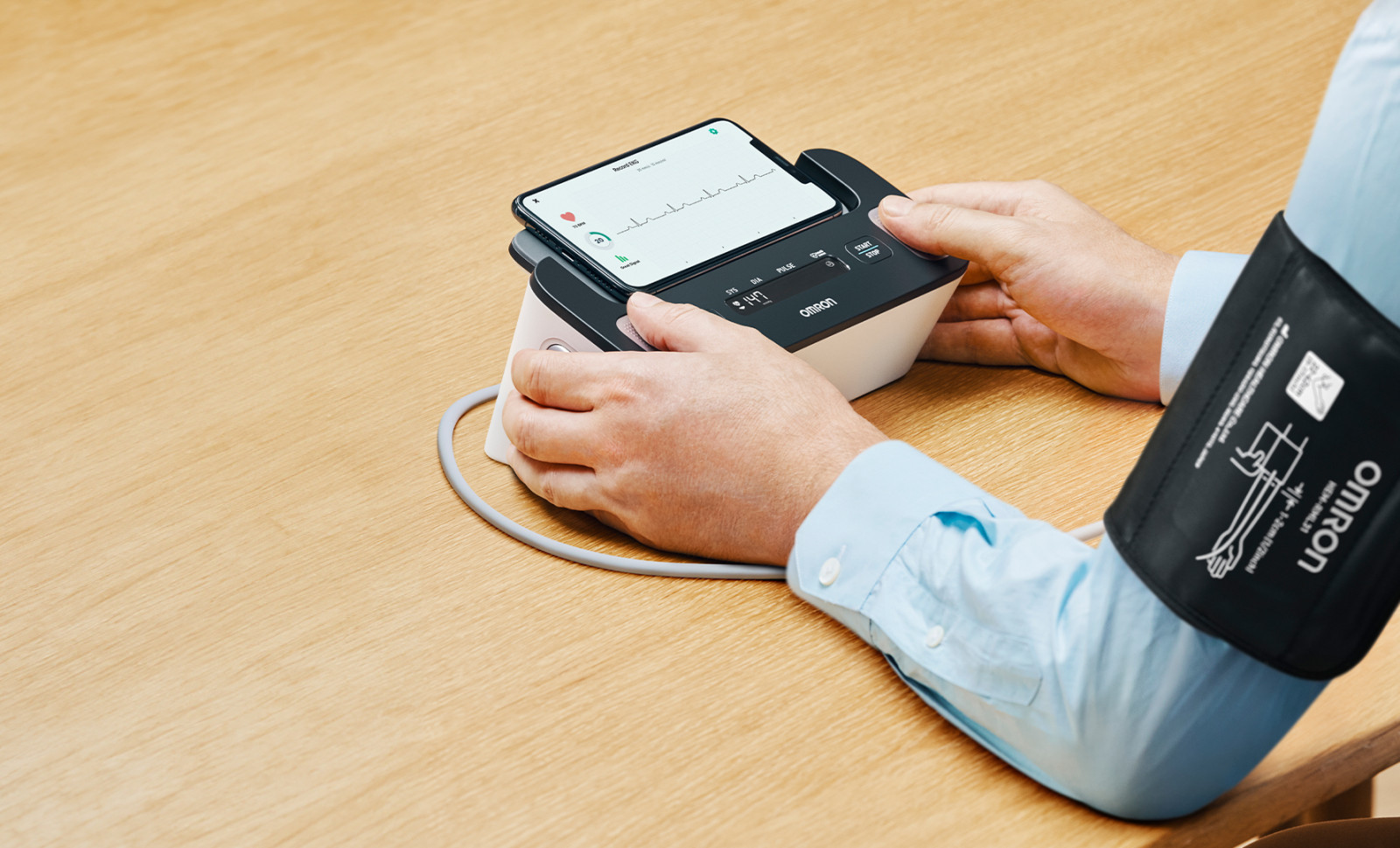 Man taking blood pressure monitor at home with Complete