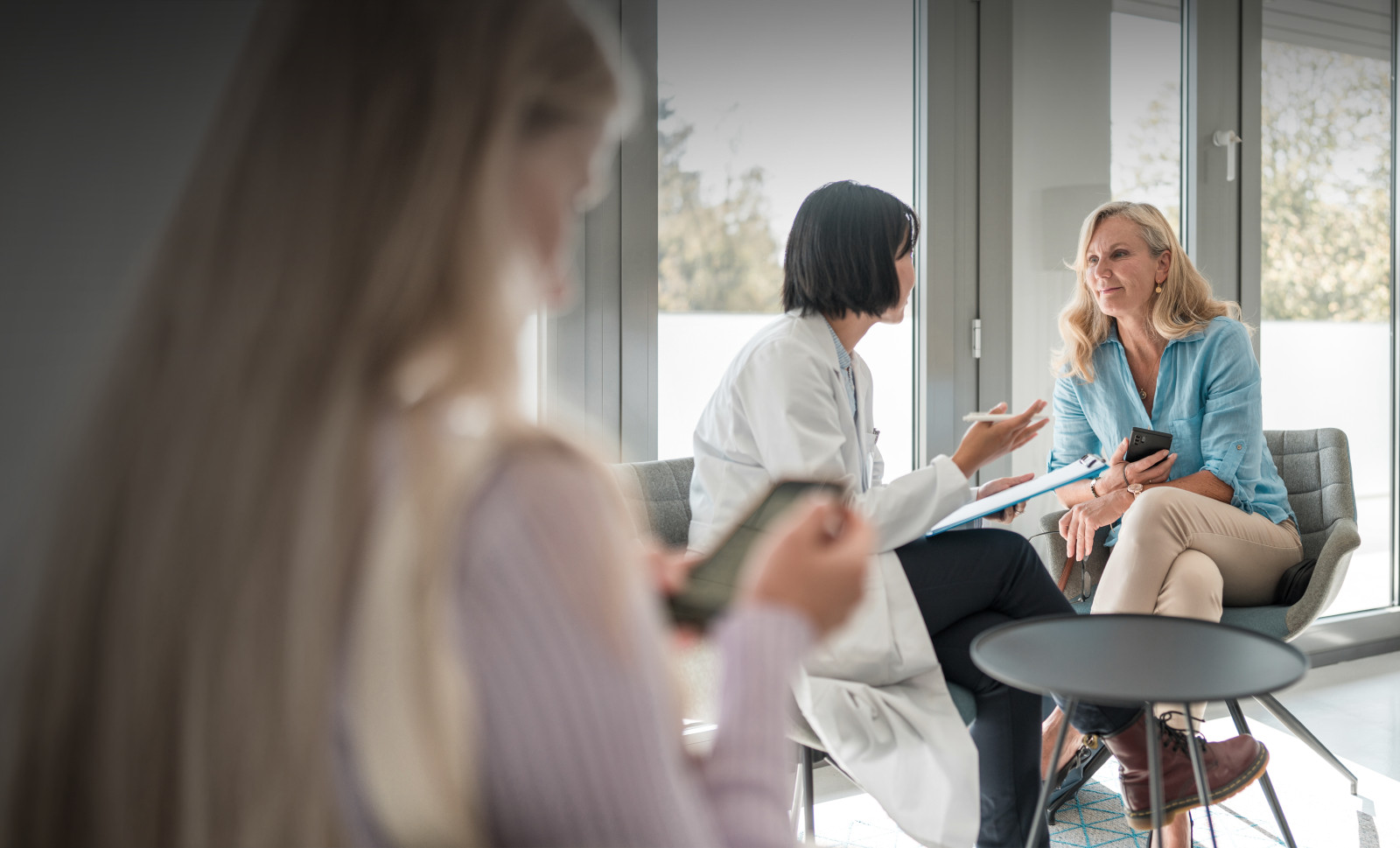 Female doctor talking to patient in office