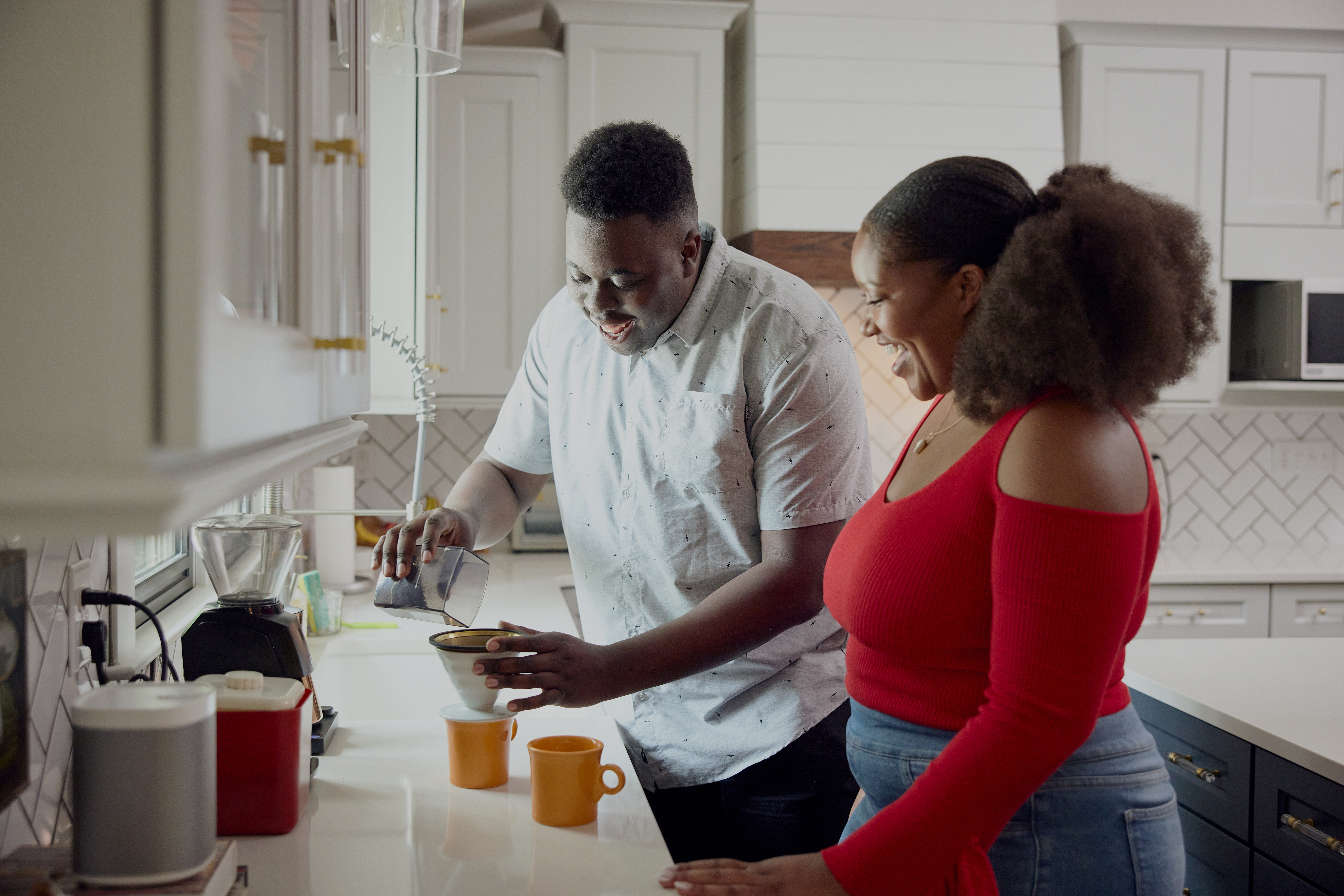 Man and woman making coffee