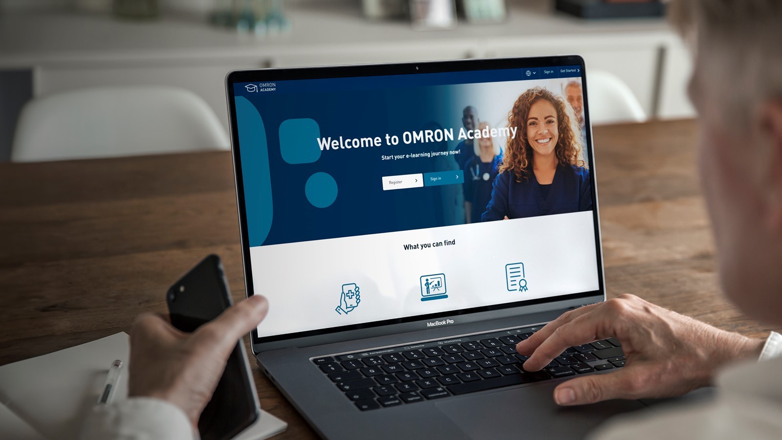 Doctor visiting OMRON Academy on laptop