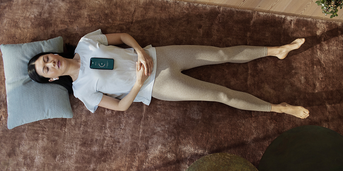 Woman laying down listening to CardioSignal