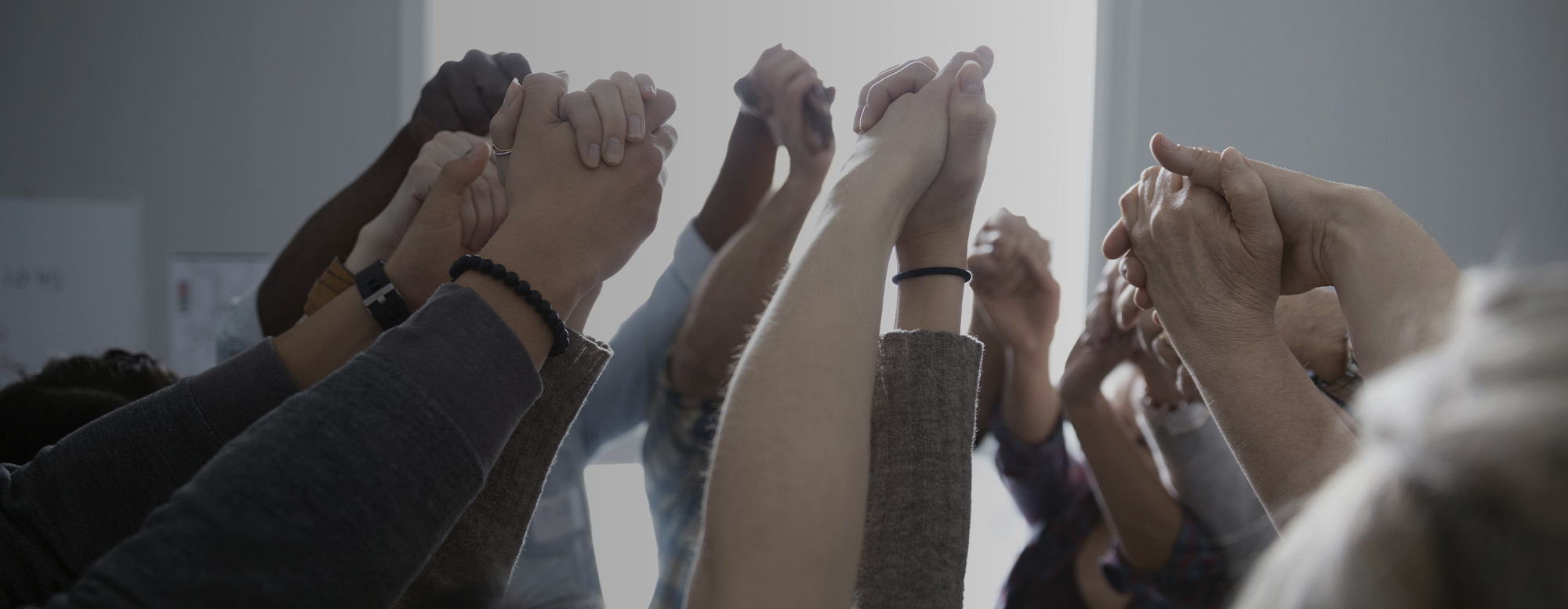 Group of people holding hands in air