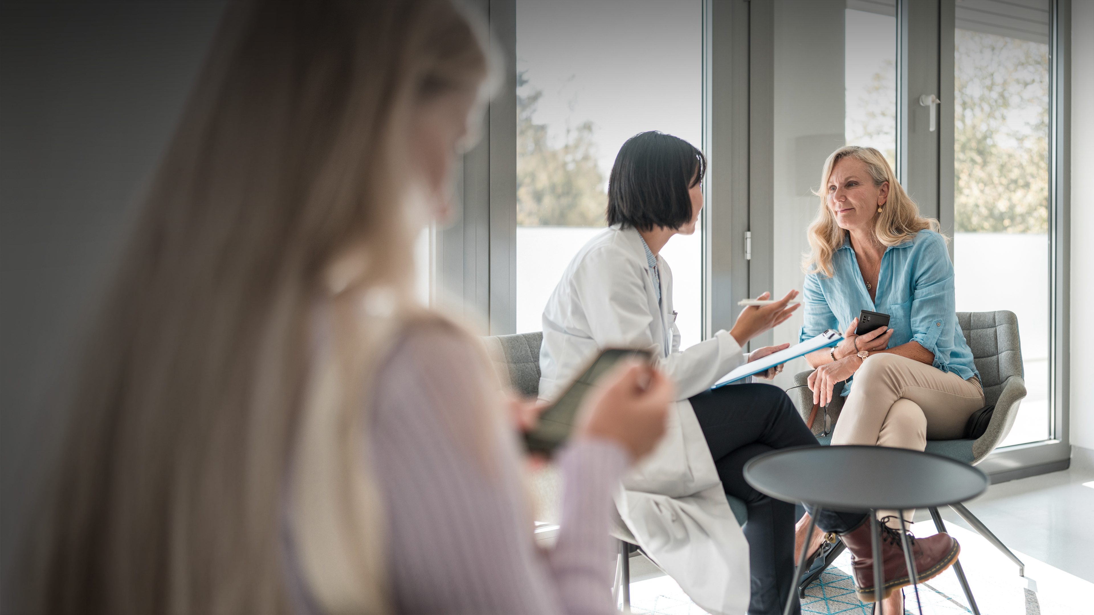 Female doctor talking to patient in office